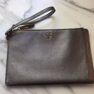 Silver metallic oversized Cole Haan wristlet.